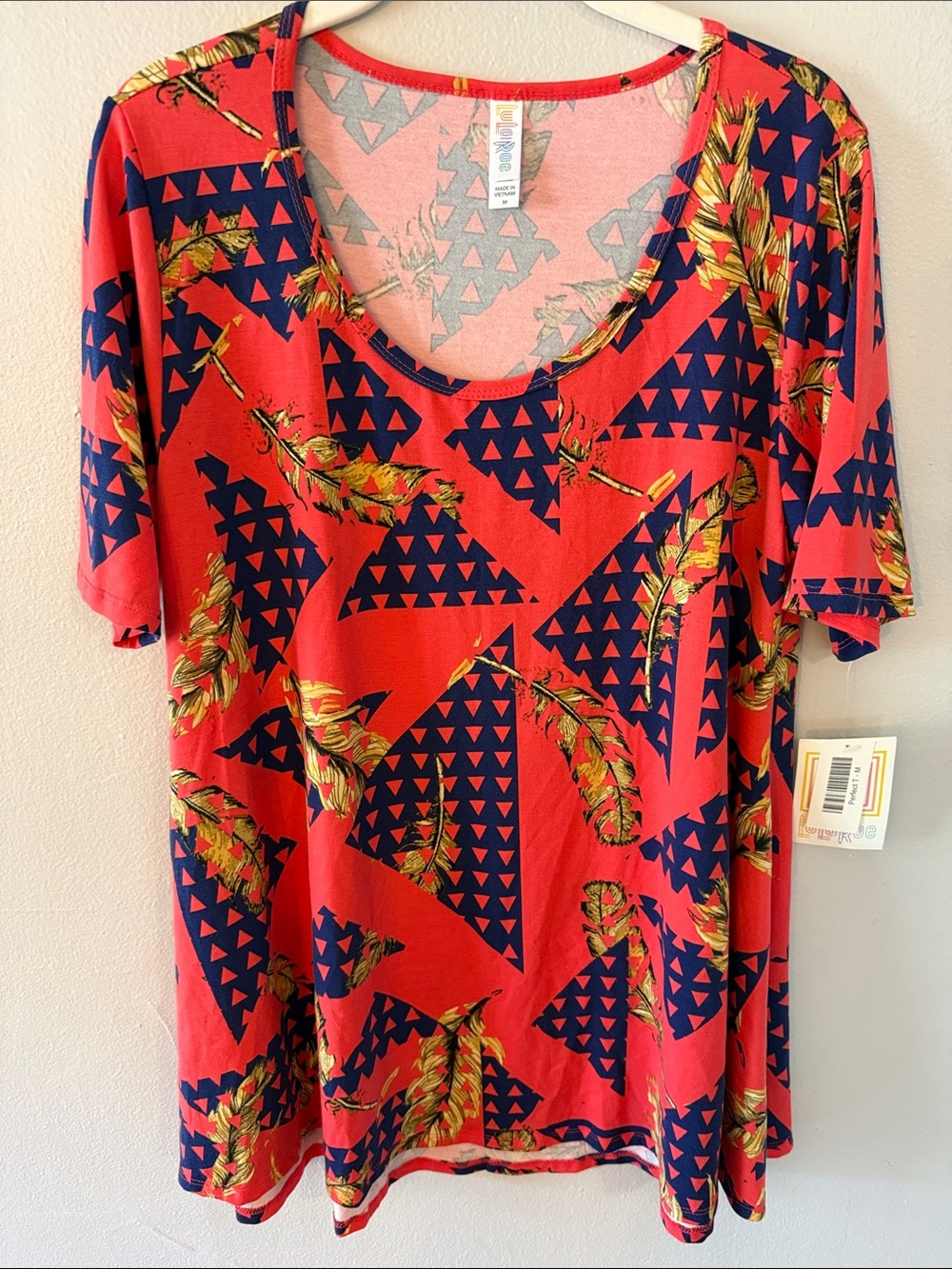 LuLaRoe Red Short Sleeve Scoop Neck Top with Navy Triangles & Gold Feather Print